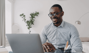 African businessman doing business online with a a laptop.