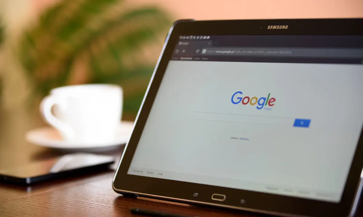 A magnifying glass over a computer screen, symbolizing the importance of SEO for financial services websites.