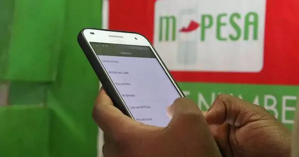 A person using M-Pesa on their phone, illustrating the importance of mobile payments for online fundraising in Kenya.
